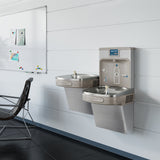 Elkay LZSTL8WSSK Wall-Mounted Drinking Fountain - A used view of the bi-level fountain, showcasing signs of wear and tear. The fountain has a white finish and features a glass filler. Despite the wear, the fountain remains functional and provides a reliable source of drinking water.